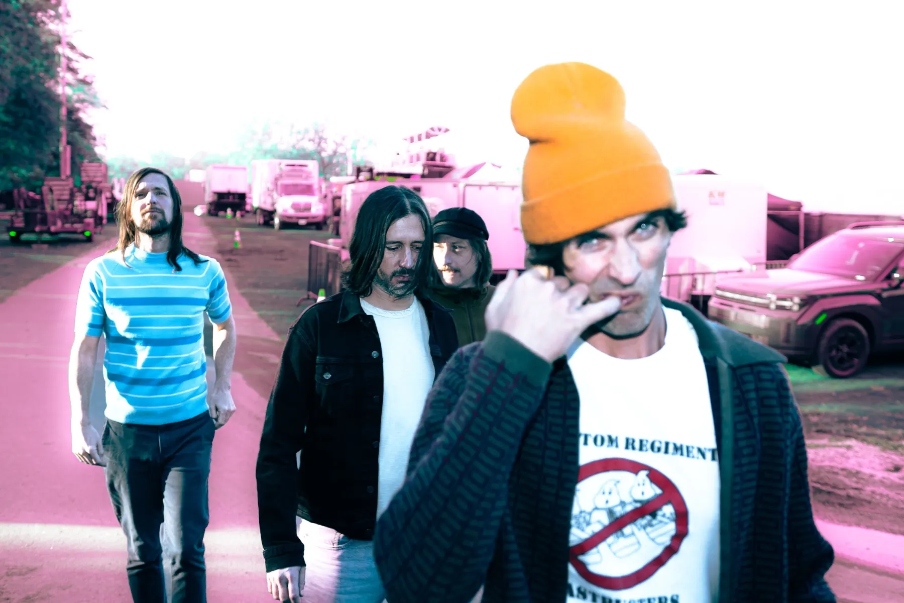 The All-American Rejects walking through a backlot, Tyson Ritter in an orange beanie